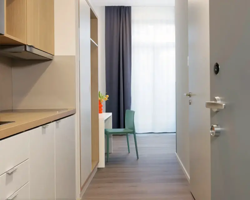 Hotelfotografie Bildbeispiel für Smartments. Es zeigt den Blick von der Eingangstür des Hotelzimmers in den Raum.